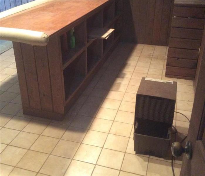 Wooden counter on white tile floor
