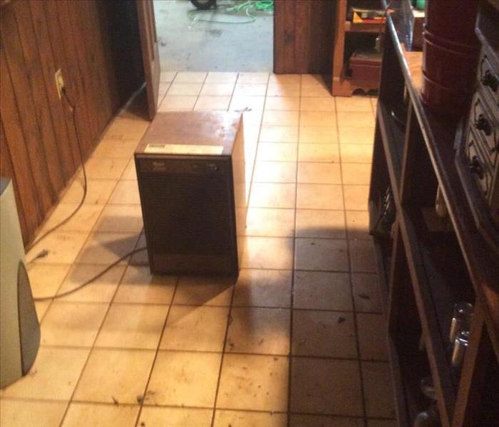 Object on wet tile floor outside a garage