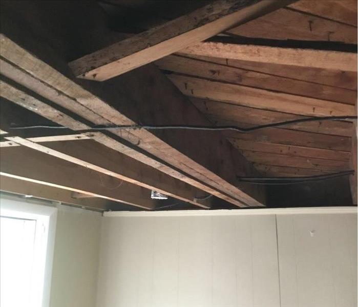 Exposed wooden planks on the ceiling of a room