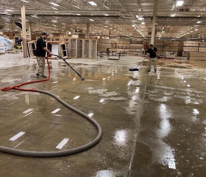SERVPRO employee extracting water from a warehouse