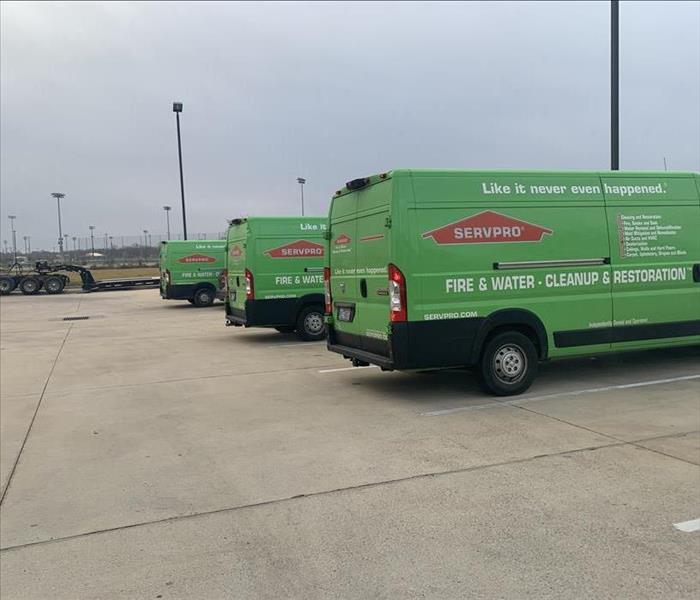 The rear of three lined-up SERVPRO vehicles