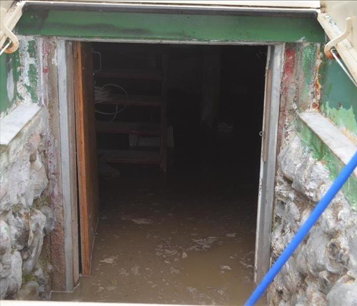 Flood waters inside a basement as seen from an outside door