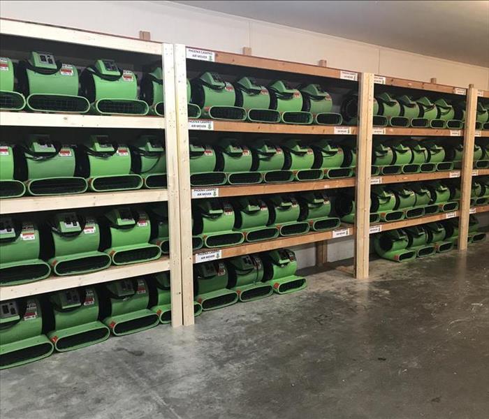 Shelves full of green air movers